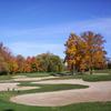 A fall view of green protected by bunkers at Whispering Springs Golf Club