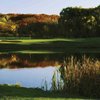 A view of green surrounded by water at Abbey Springs Golf Course