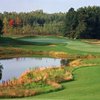 An autumn view of a green surrounded by water at Eagle Creek Golf Club