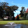 A view of green with water fountain in foreground at Luck Golf Course 
